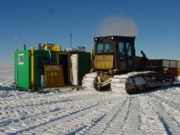 Caterpillar tractor clearing snow in front of the AASTO (click to enlarge; 1.31 MB)